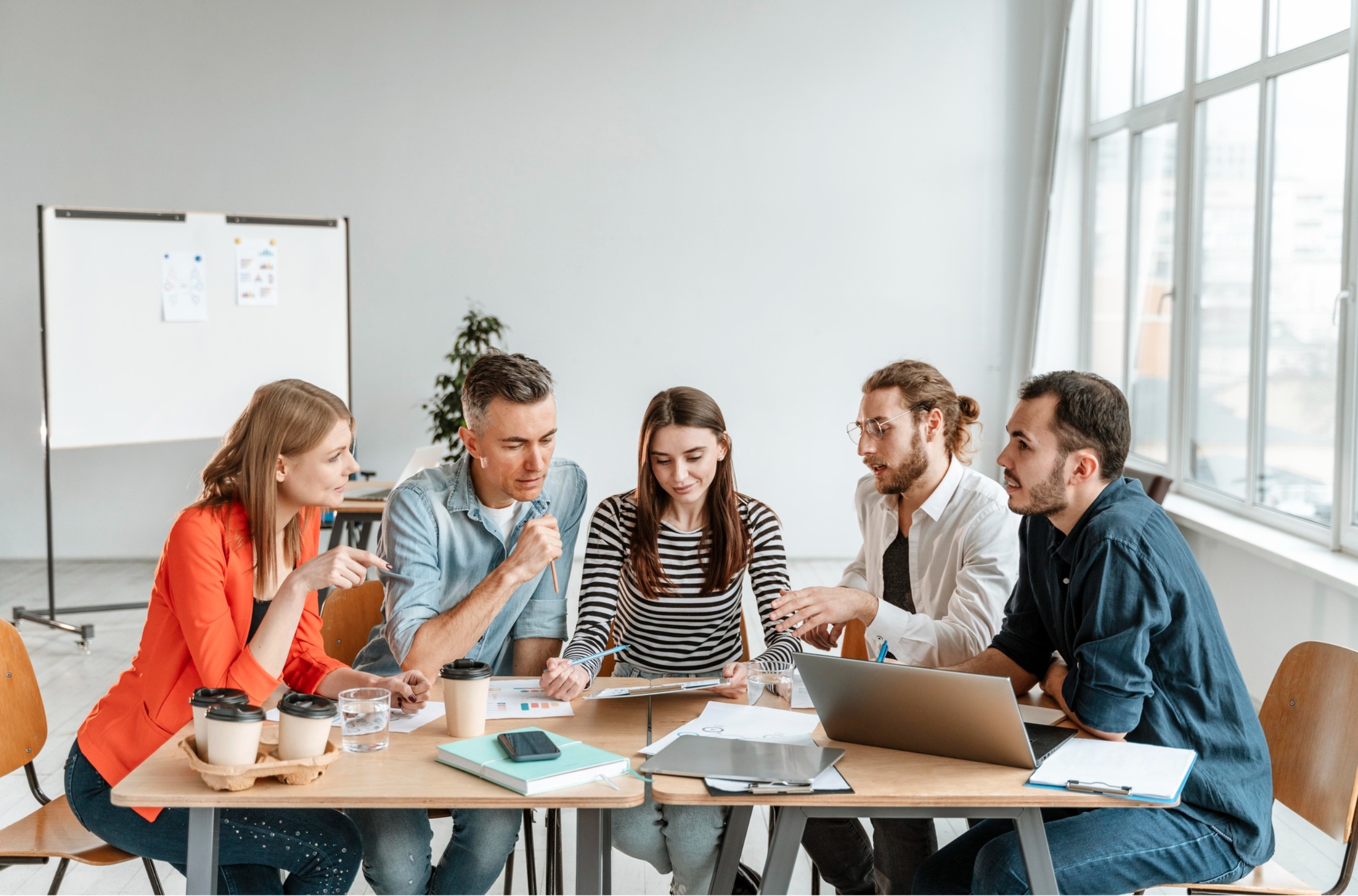 Group of focused students in a bright modern classroom discussing and taking notes during a hands-on session at GS Trainings Lahore.